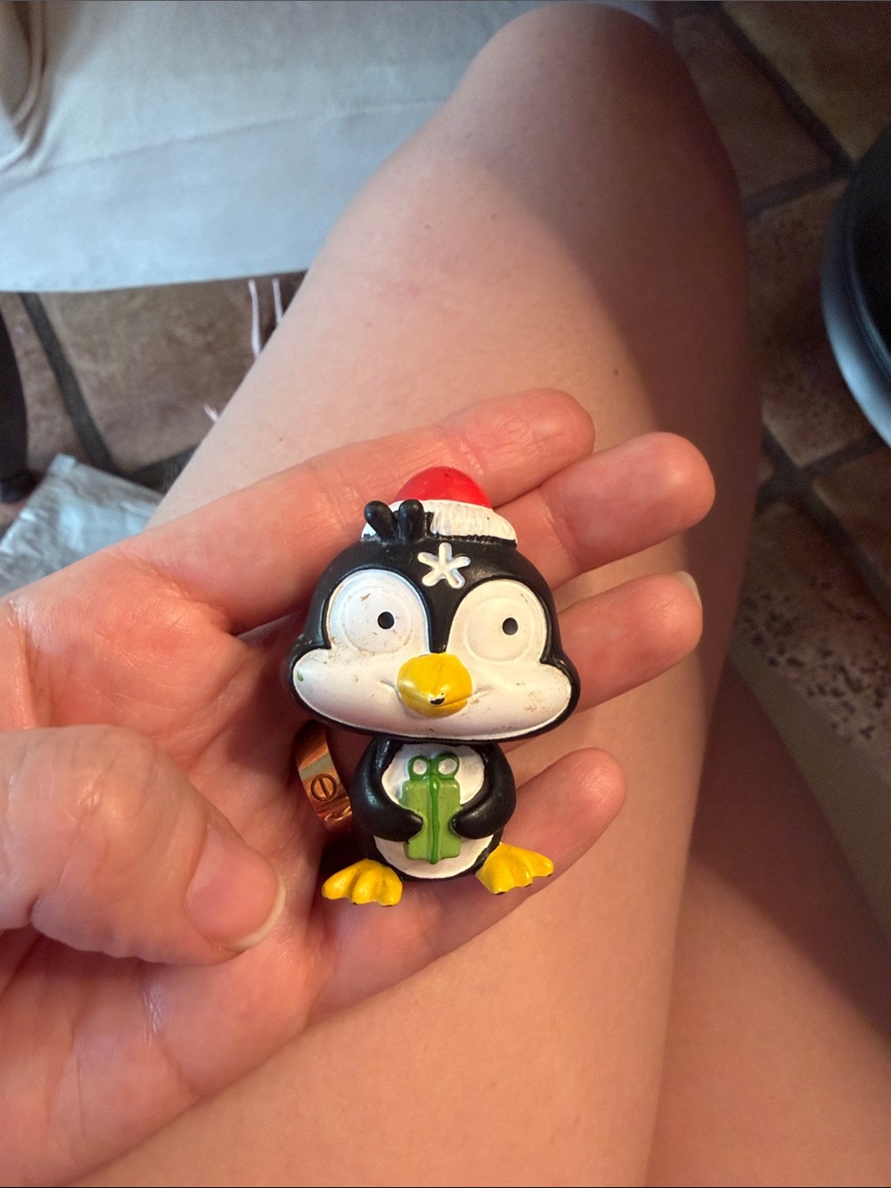Tonies Black Penguin Holiday Figurine Toy with Red Hat and Yellow Accents